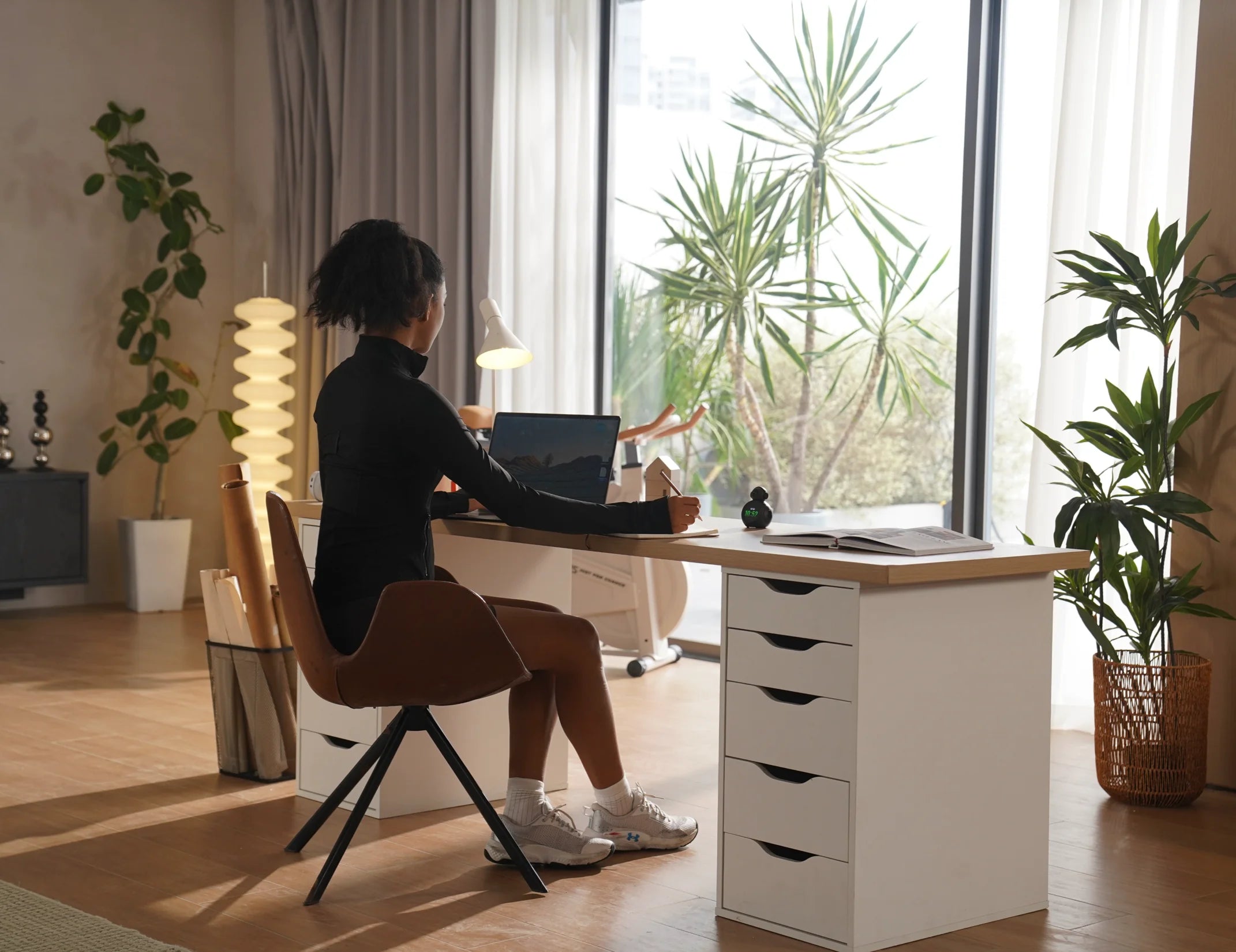 Woman working at a desk with ATOM Pomodoro posture reminder