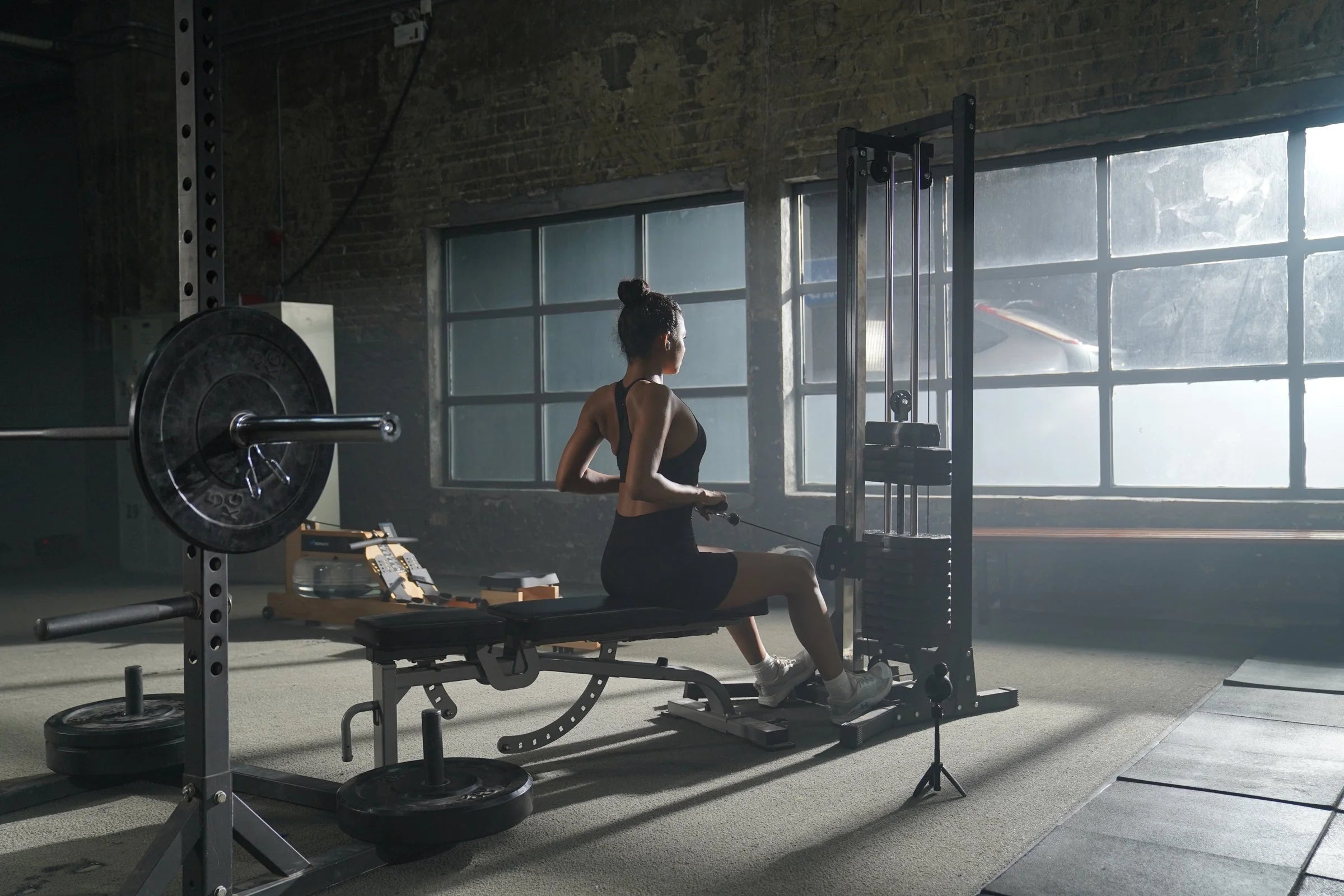 Athlete using voice and gesture control at a cable machine
